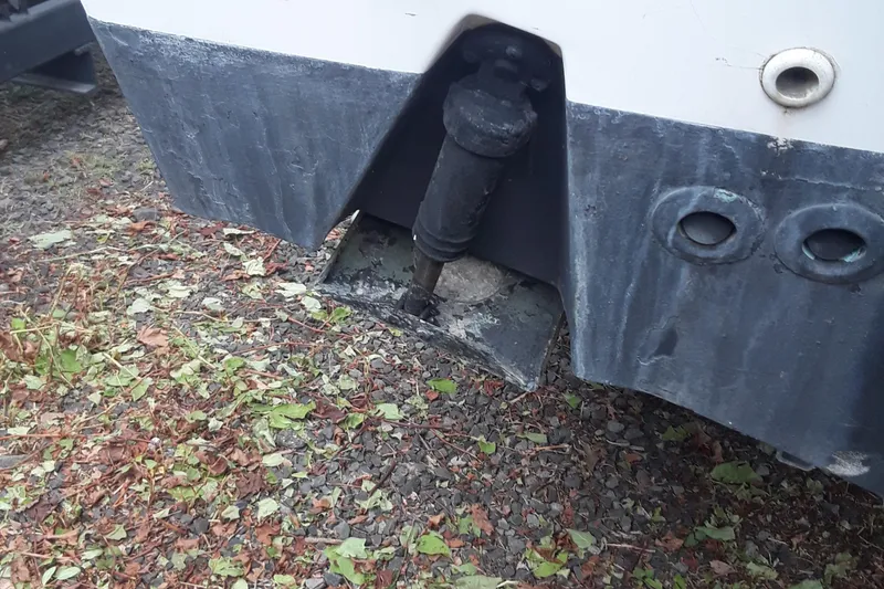 Slide: The Image of Close-up of a 2001 Boston Whaler 260 Outrage boat hull on gravel. - 29