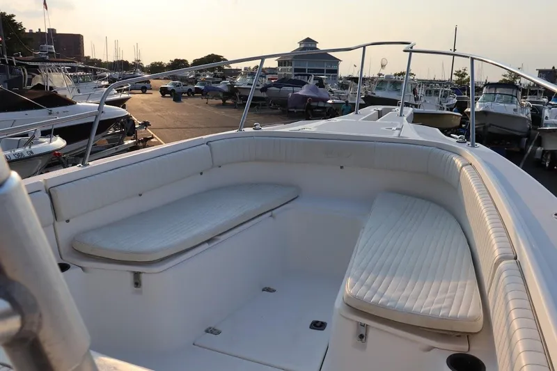 Slide: The Image of 2001 Boston Whaler 260 Outrage boat interior with white seating at marina. - 30