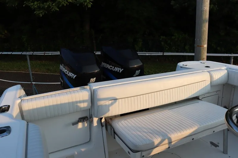 Slide: The Image of 2001 Boston Whaler 260 Outrage boat with twin Mercury engines and white seating. - 6