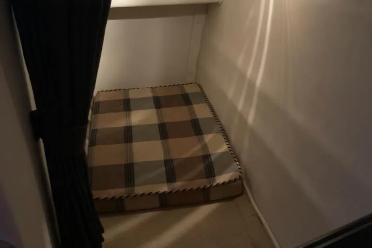 Slide: The Image of 2004 Monterey 265 Cruiser cabin with plaid cushion and curtain. - 10