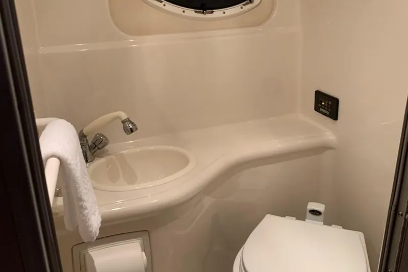 Slide: The Image of Compact bathroom in 2004 Monterey 265 Cruiser with sink, toilet, and towel rack. - 11