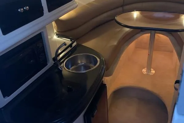 Slide: The Image of 2004 Monterey 265 Cruiser interior with kitchenette and cozy seating area. - 7