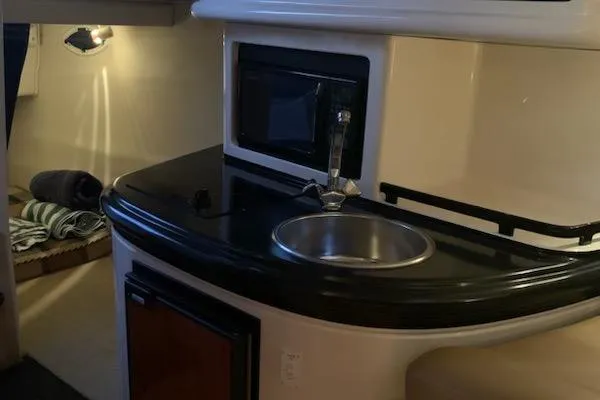 Slide: The Image of 2004 Monterey 265 Cruiser interior with kitchenette, sink, and microwave. - 8