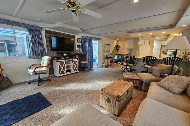 Slide: The Image of Luxurious 2002 Jamestowner houseboat interior with cozy seating, TV, and elegant decor. - 18