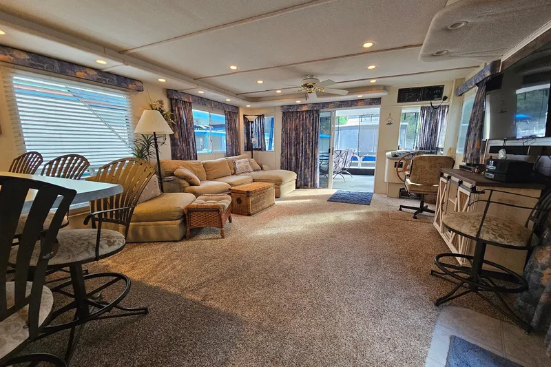 Slide: The Image of Spacious 2002 Jamestowner houseboat interior with cozy seating, dining area, and natural light. - 19