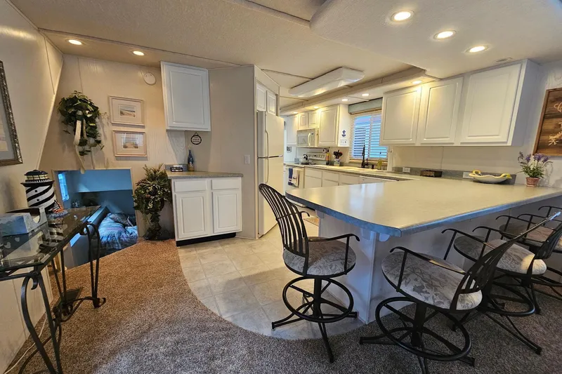 Slide: The Image of Spacious 2002 Jamestowner houseboat interior with modern kitchen and bar seating. - 21