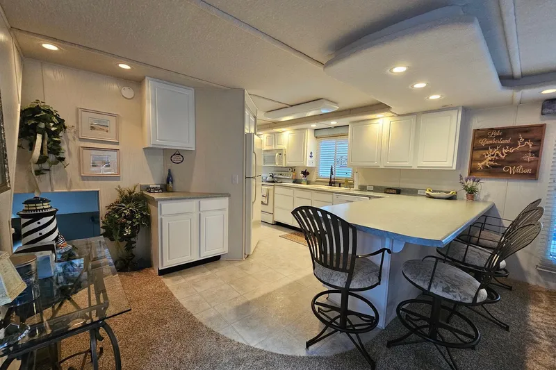 Slide: The Image of Interior of a 2002 Jamestowner houseboat with modern kitchen and bar seating. - 23