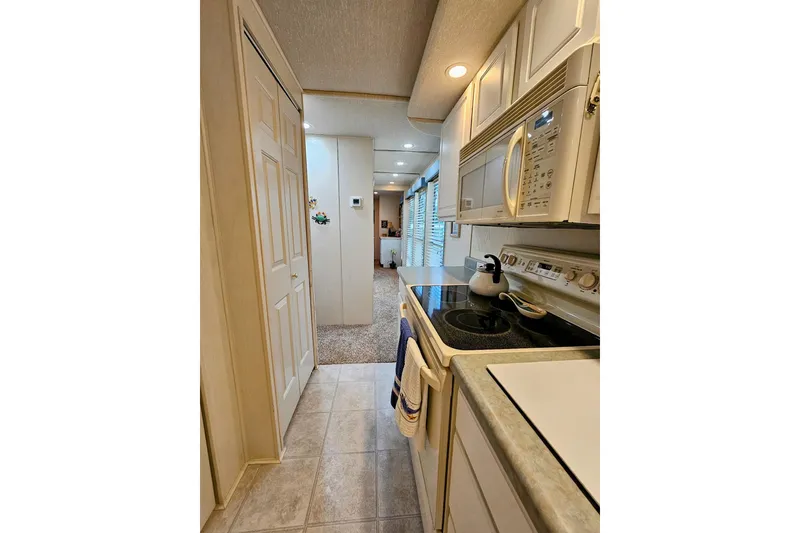 Slide: The Image of Interior of 2002 Jamestowner houseboat kitchen with modern appliances and cozy design. - 25