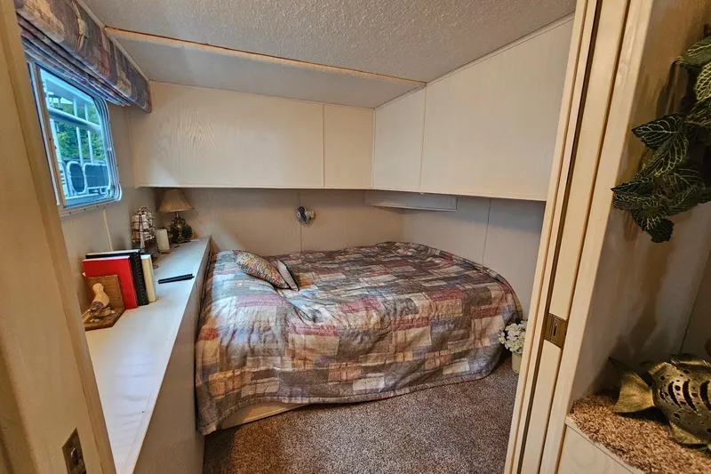 Slide: The Image of Cozy bedroom in 2002 Jamestowner houseboat with patterned bedding and decorative accents. - 29