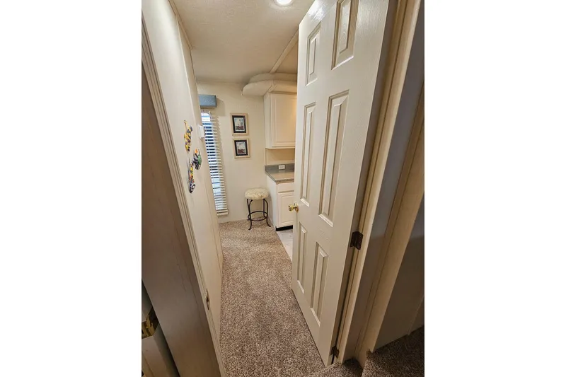 Slide: The Image of Interior hallway of a 2002 Jamestowner houseboat with carpet and decor. - 31