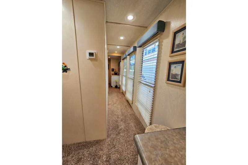 Slide: The Image of Interior hallway of 2002 Jamestowner houseboat with carpet and framed pictures. - 32