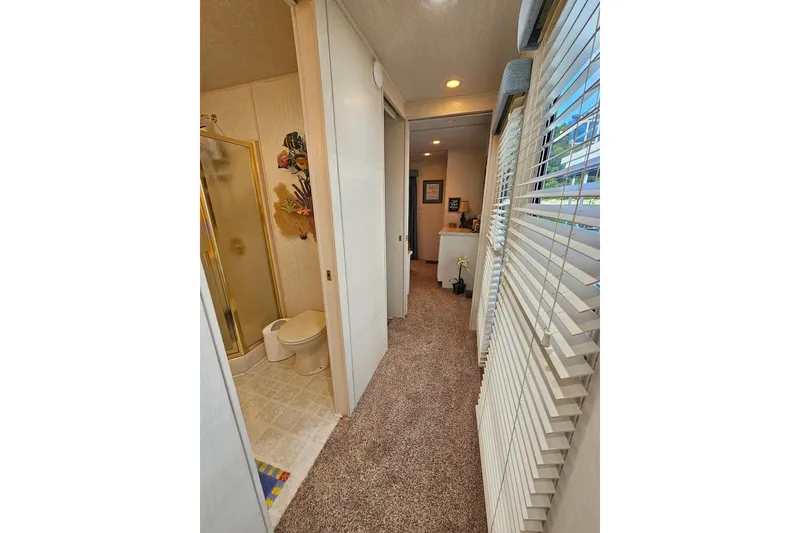 Slide: The Image of Interior of 2002 Jamestowner houseboat with bathroom and hallway view. - 34