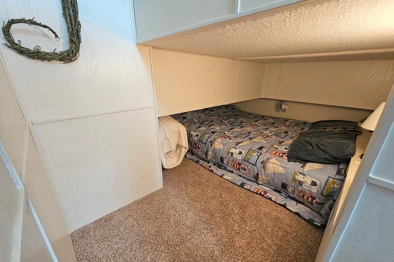 Slide: The Image of Cozy bedroom in 2002 Jamestowner houseboat with nautical-themed bedding and carpeted floor. - 36