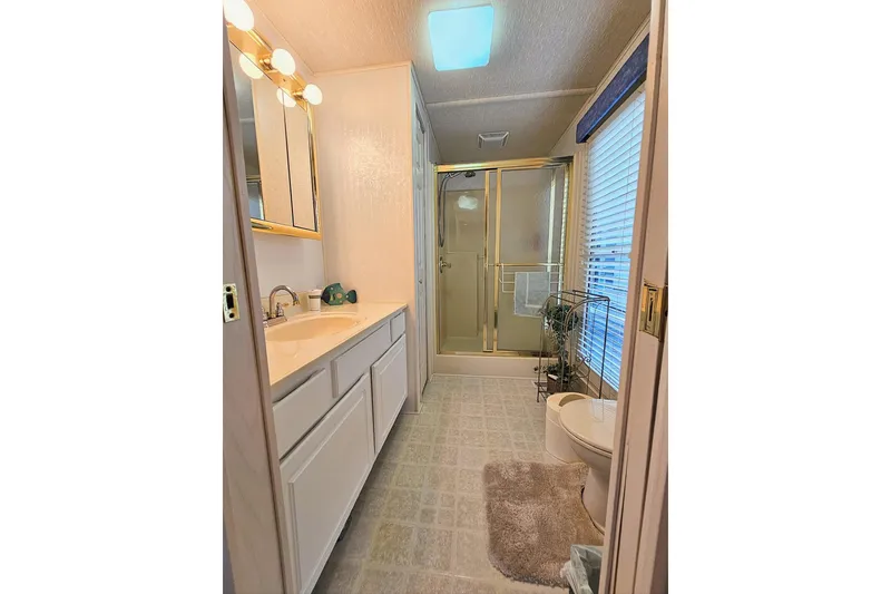 Slide: The Image of Bathroom interior of 2002 Jamestowner houseboat with shower, vanity, and toilet. - 37