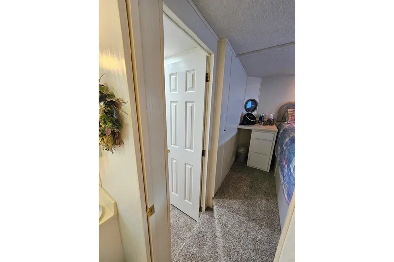 Slide: The Image of Interior of 2002 Jamestowner houseboat bedroom with carpet and dresser. - 39