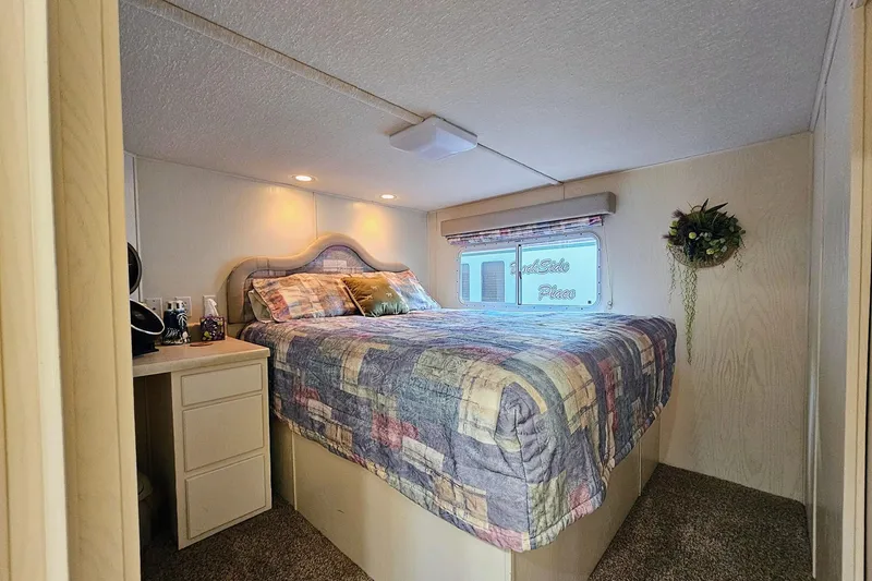 Slide: The Image of Cozy bedroom in 2002 Jamestowner houseboat with colorful quilt and natural light. - 42