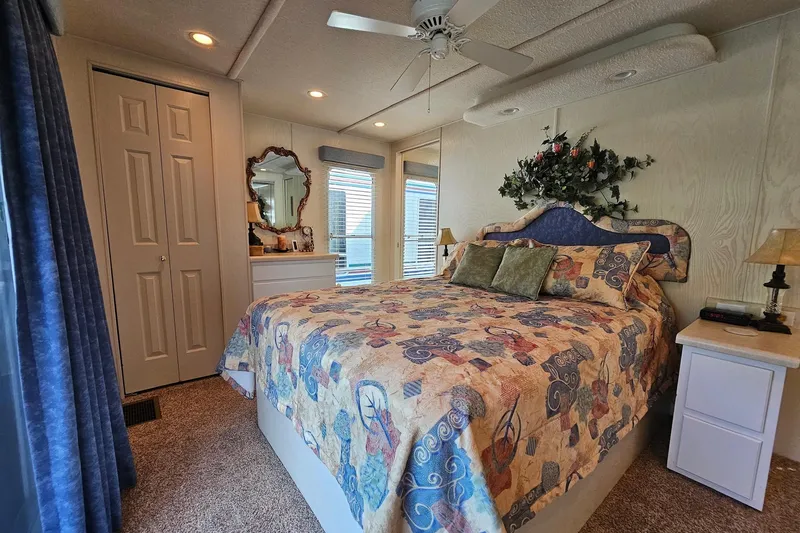 Slide: The Image of Cozy bedroom in a 2002 Jamestowner houseboat with floral decor and patterned bedding. - 45