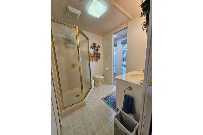 Slide: The Image of Bathroom interior of 2002 Jamestowner houseboat with shower, toilet, and sink. - 47