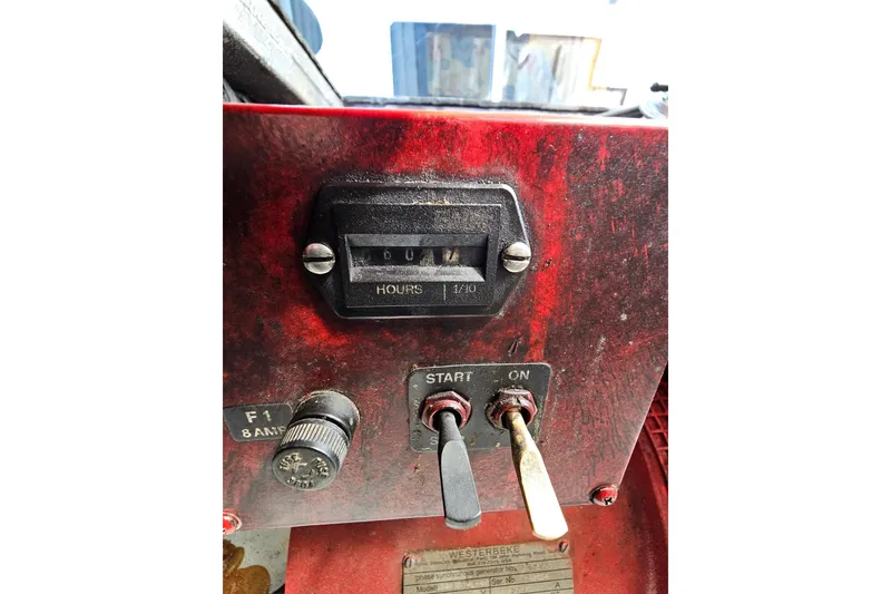 Slide: The Image of Control panel of a 2002 Jamestowner houseboat with hour meter and switches. - 52