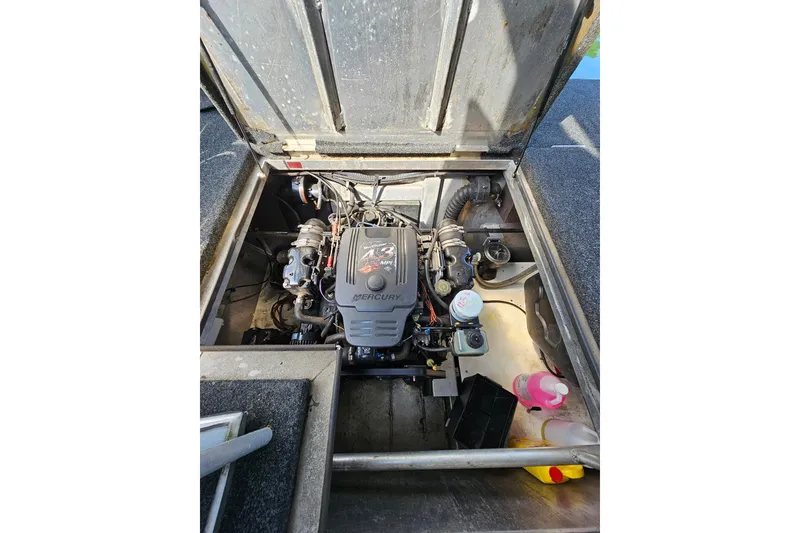 Slide: The Image of Engine compartment of a 2002 Jamestowner houseboat, featuring a Mercury engine. - 53