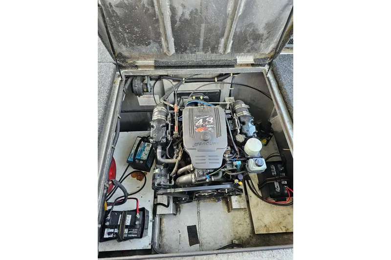 Slide: The Image of Engine compartment of a 2002 Jamestowner houseboat, featuring a Mercury engine. - 54