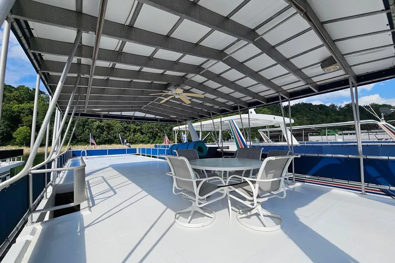 Slide: The Image of 2002 Jamestowner houseboat deck with seating, covered roof, and scenic view. - 6