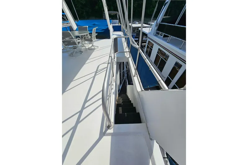Slide: The Image of 2002 Jamestowner houseboat deck with stairs and outdoor seating area. - 8