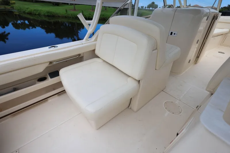 Slide: The Image of 2018 Grady-White Freedom 285 boat interior with white seating and sleek design. - 13