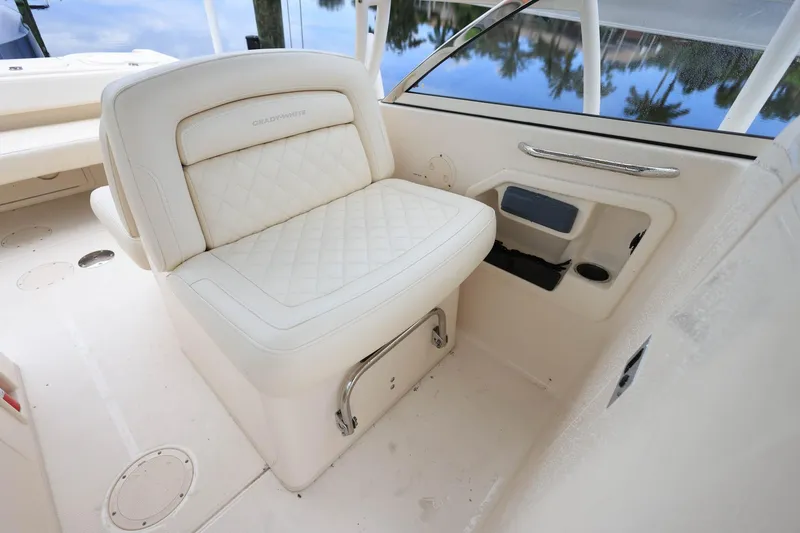 Slide: The Image of 2018 Grady-White Freedom 285 boat interior with cushioned seating and storage. - 14