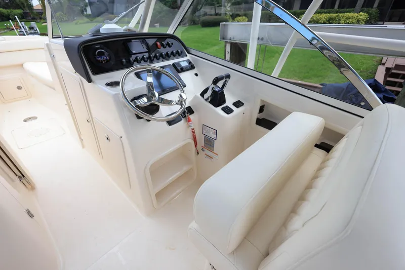 Slide: The Image of 2018 Grady-White Freedom 285 boat cockpit with steering wheel and control panel. - 16