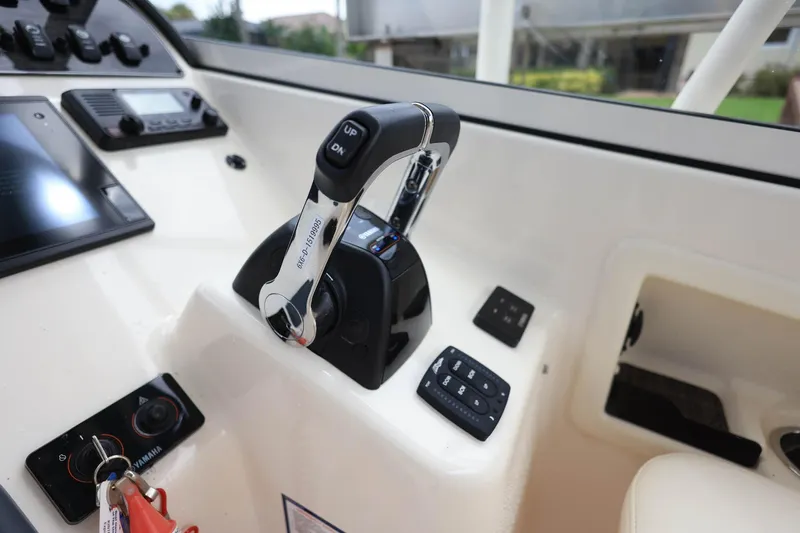 Slide: The Image of Control panel of 2018 Grady-White Freedom 285 boat with throttle and switches. - 21