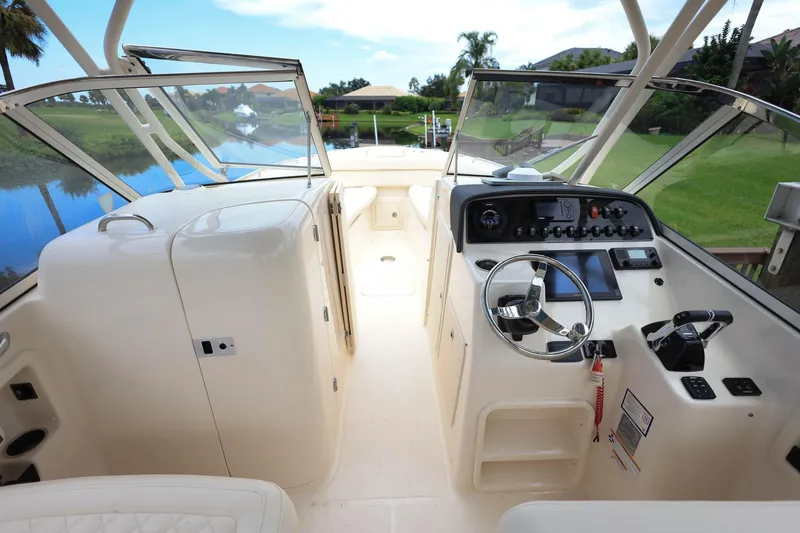 Slide: The Image of 2018 Grady-White Freedom 285 boat interior with steering wheel and control panel. - 22
