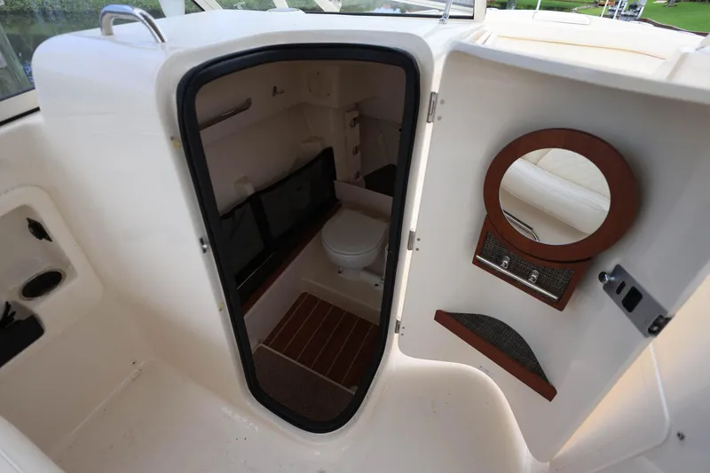 Slide: The Image of 2018 Grady-White Freedom 285 boat interior with compact bathroom and mirror. - 23