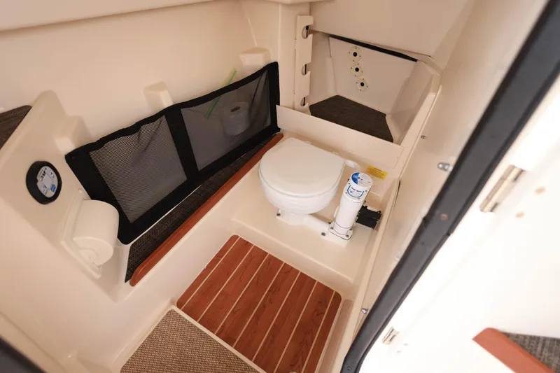 Slide: The Image of 2018 Grady-White Freedom 285 boat interior with toilet and storage area. - 24
