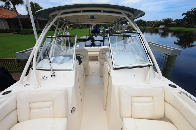 Slide: The Image of 2018 Grady-White Freedom 285 boat docked by a serene waterfront. - 25