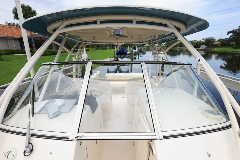 Slide: The Image of 2018 Grady-White Freedom 285 boat with spacious cockpit and sleek design on a calm waterway. - 26