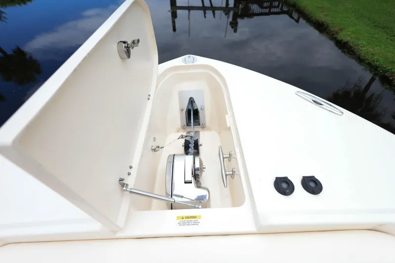 Slide: The Image of Anchor compartment of 2018 Grady-White Freedom 285 boat, open with visible anchor and chain. - 28