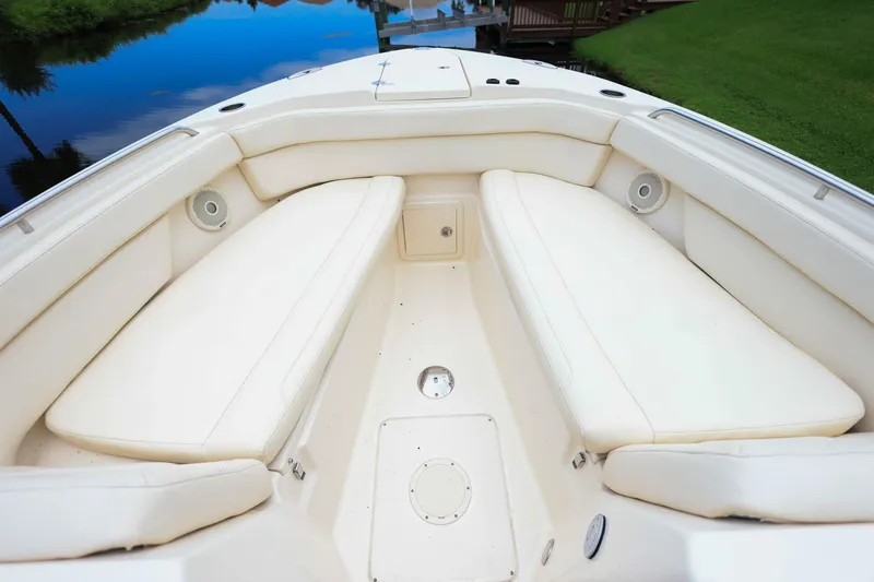 Slide: The Image of 2018 Grady-White Freedom 285 boat interior with cushioned seating and speakers. - 29