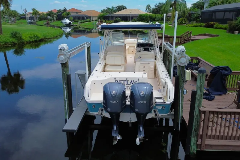 Slide: The Image of 2018 Grady-White Freedom 285 boat docked on a serene waterfront. - 6