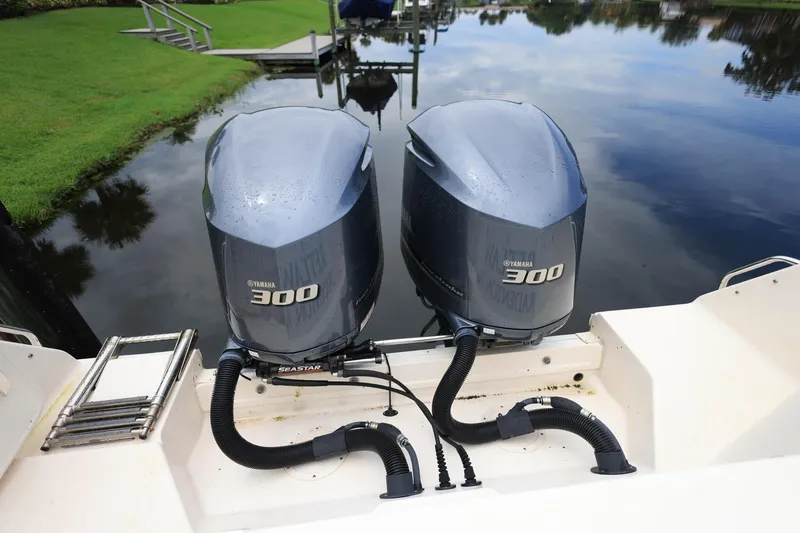 Slide: The Image of 2018 Grady-White Freedom 285 boat with twin Yamaha 300 engines on a calm waterway. - 7