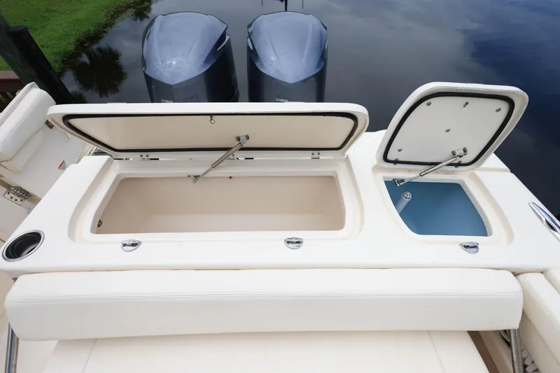 Slide: The Image of 2018 Grady-White Freedom 285 boat with open storage compartments and twin engines. - 8