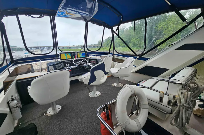 Slide: The Image of Interior view of 1990 Sea Ray 440 Aft Cabin yacht with helm and seating. - 10