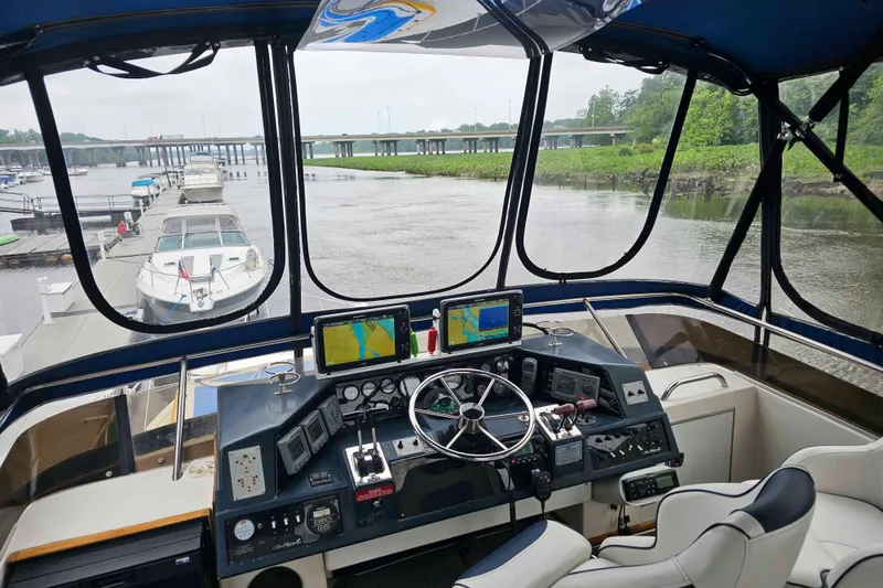 Slide: The Image of Cockpit view of 1990 Sea Ray 440 Aft Cabin yacht with navigation equipment. - 12