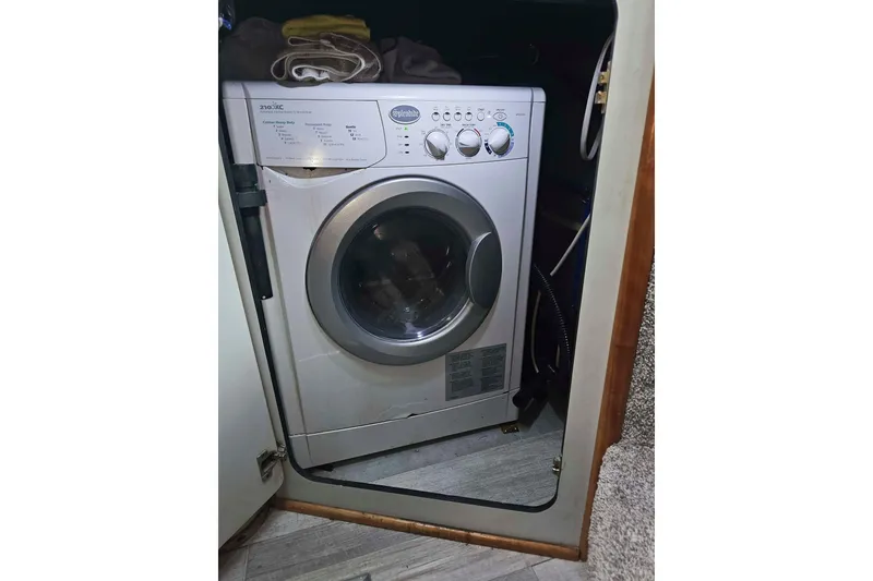 Slide: The Image of Washing machine inside 1990 Sea Ray 440 Aft Cabin boat, compact laundry solution. - 29