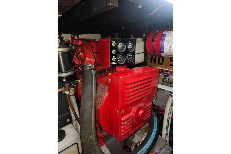 Slide: The Image of Engine room of 1990 Sea Ray 440 Aft Cabin with red machinery and gauges. - 34