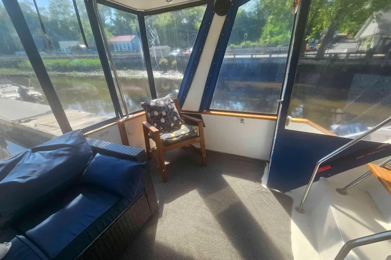 Slide: The Image of Interior of 1990 Sea Ray 440 Aft Cabin with cozy seating and river view. - 8