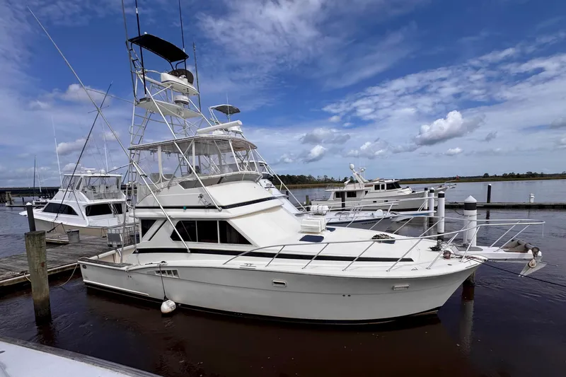 The Image of 1987 Chris-Craft 422 Commander yacht docked at marina under blue sky. - 0