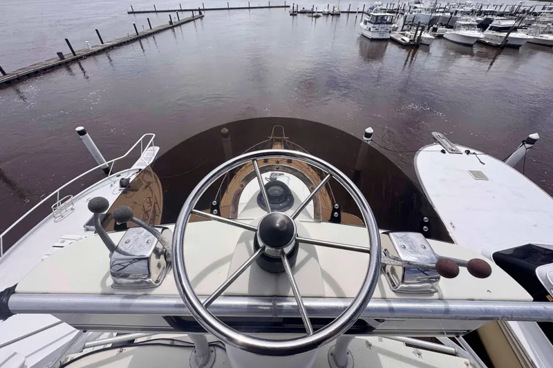 Slide: The Image of 1987 Chris-Craft 422 Commander yacht helm with marina view. - 13