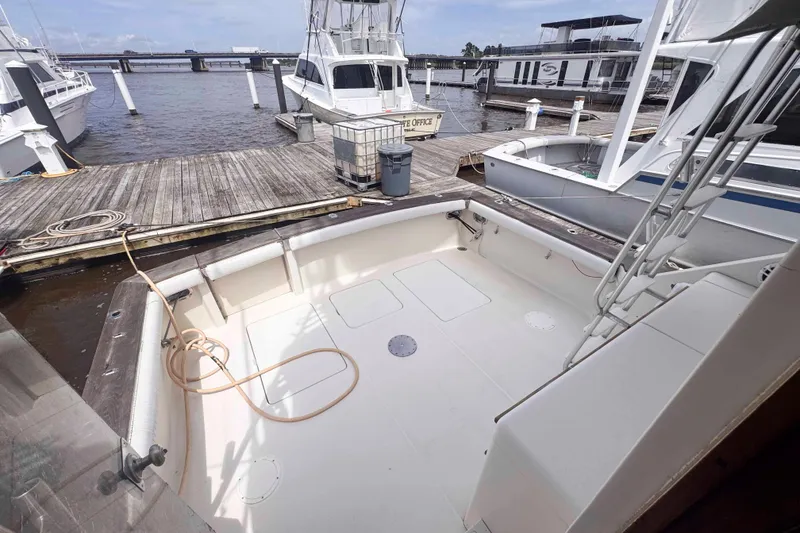 Slide: The Image of 1987 Chris-Craft 422 Commander docked, showcasing spacious deck and marina view. - 2