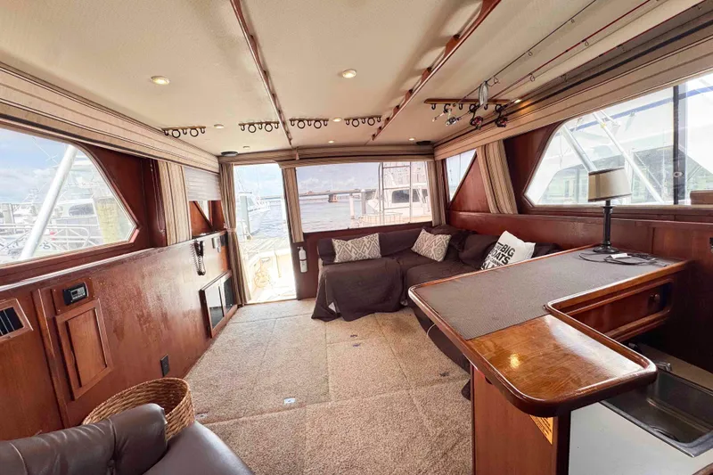 Slide: The Image of Luxurious interior of 1987 Chris-Craft 422 Commander yacht with plush seating and wooden accents. - 23